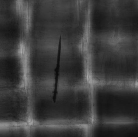 X-ray cargo scan with a concealed sharp object flagged